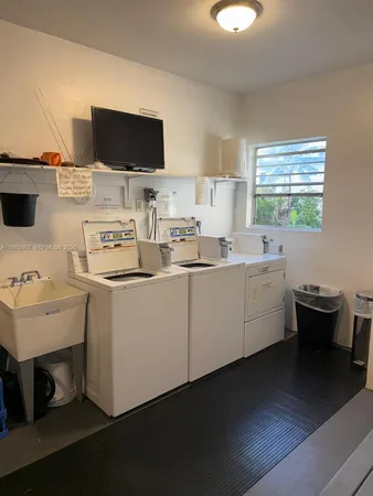 a kitchen with a sink and a stove top oven