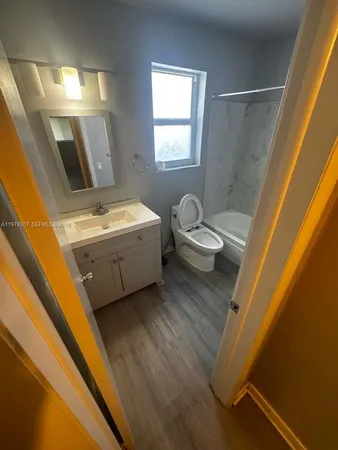 a bathroom with a sink a toilet and bathtub