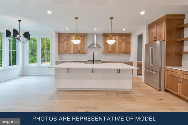 a view of kitchen with stainless steel appliances granite countertop a sink and a refrigerator