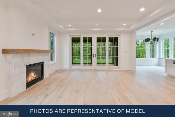 a view of an empty room with a fireplace and a window