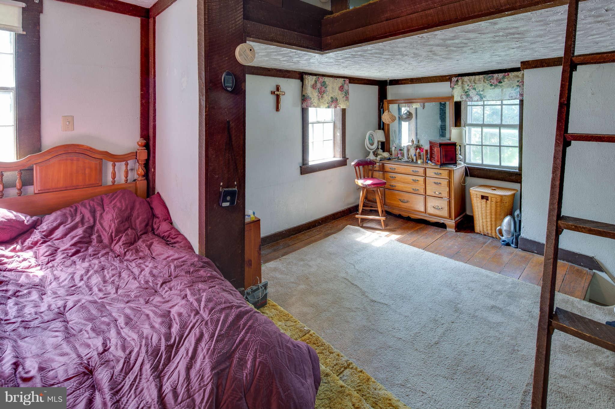 10537 Green Valley Road Union Bridge, MD 21791 - Photo 21 of 30 a bed sitting in a room next to a window