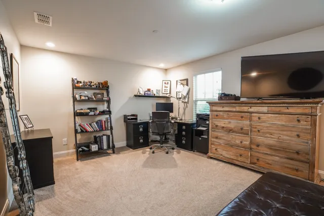 a view of walk in closet with clothes