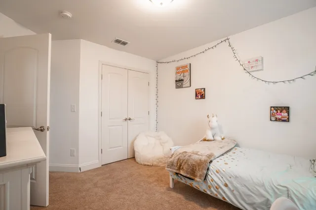 a bedroom with a bed and a chandelier