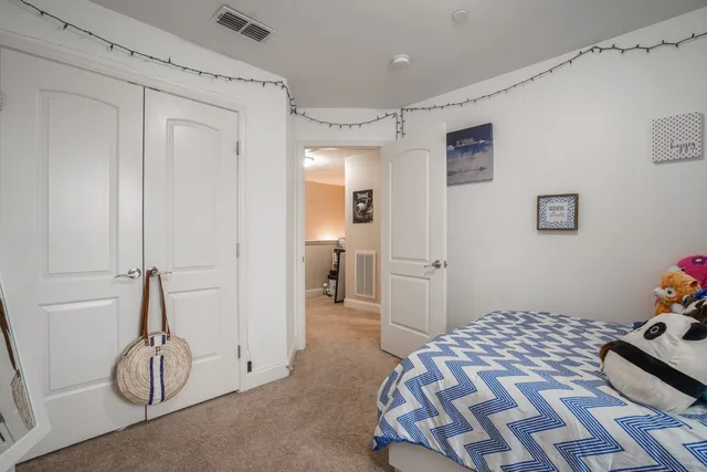 a bedroom with a bed and a large mirror