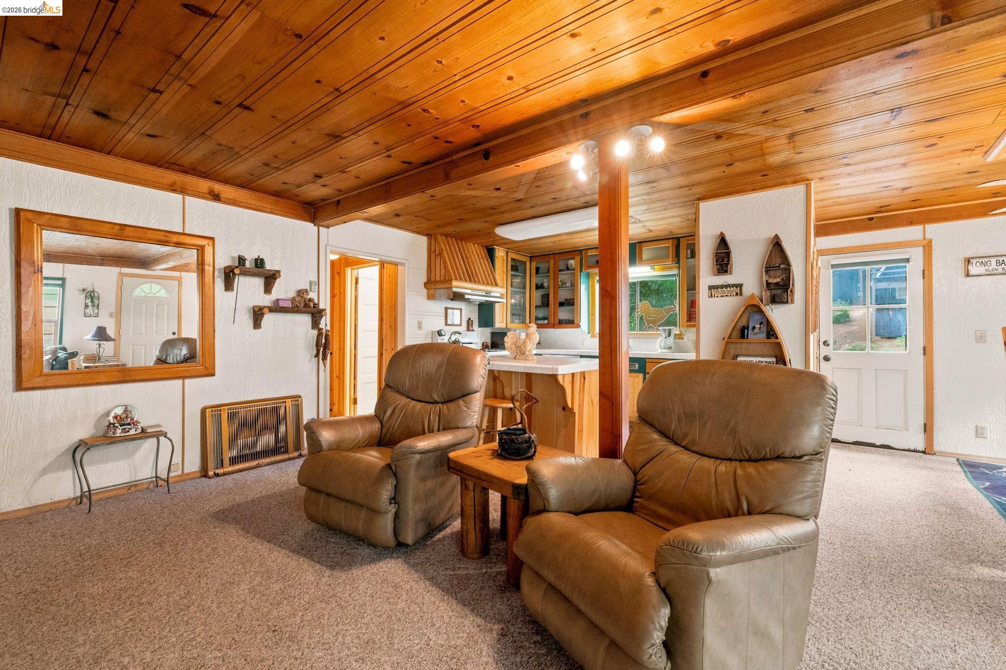 25822 Long Barn Sugar Pine Road Long Barn, CA 95335 - Photo 9 of 28 a living room with furniture ceiling fan and a rug