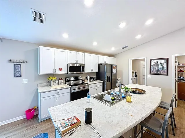 a kitchen that has a sink and a stove top oven
