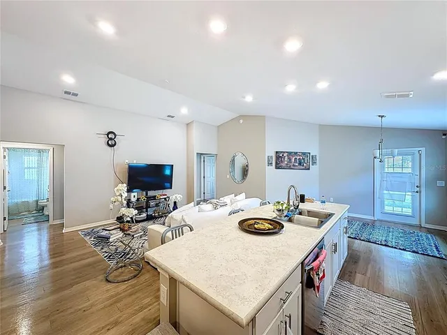 a kitchen with stainless steel appliances a refrigerator sink and stove