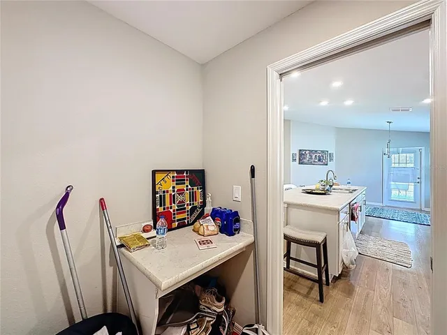 a bedroom with a bed and a flat tv screen on dresser