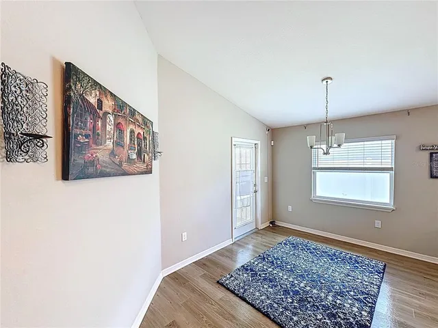 a view of a room with furniture and wooden floor