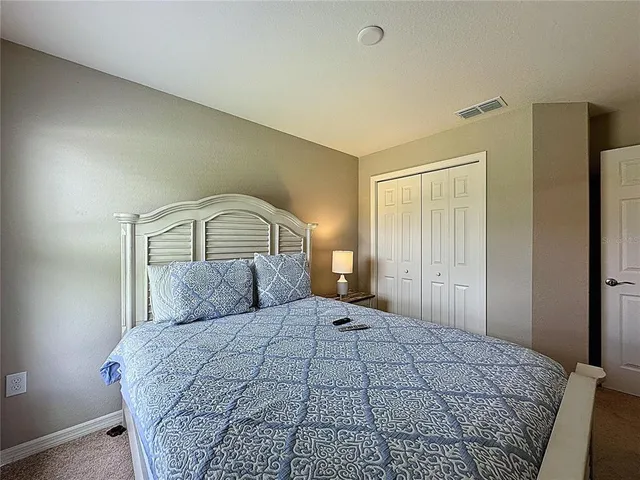 a bedroom with a bed and dresser