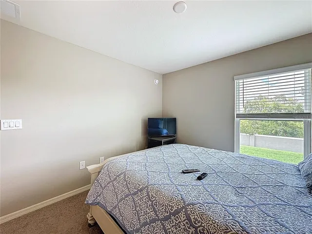 a bedroom with a bed and window