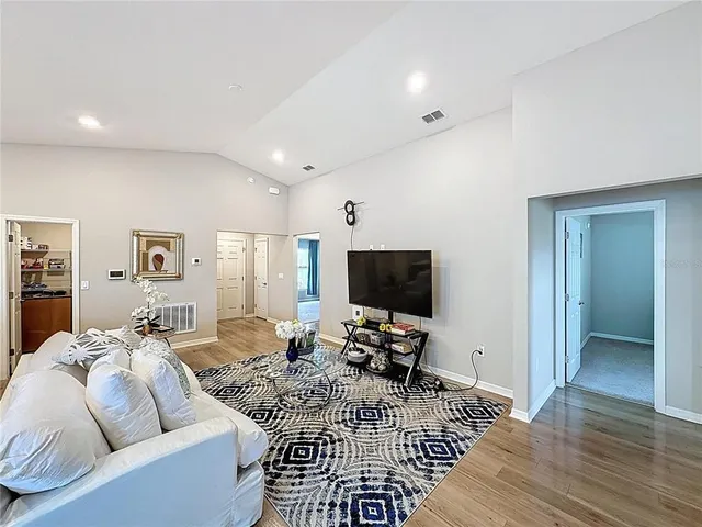 a living room with furniture and kitchen view