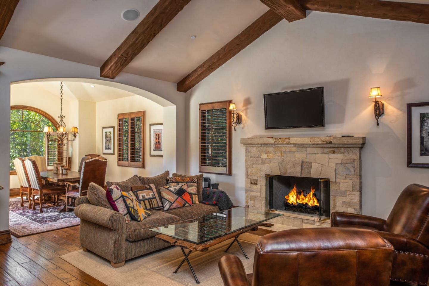 1010 Ocean Road Pebble Beach, CA 93953 - Photo 14 of 32 a living room with furniture a fireplace and a flat screen tv