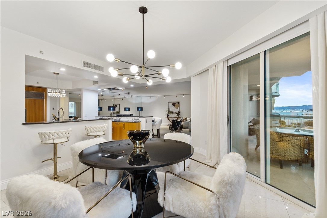 2857 Paradise Road, Unit 602 Las Vegas, NV 89109 - Photo 11 of 33 Sliding glass doors open from the dining space to a private balcony overlooking the water.