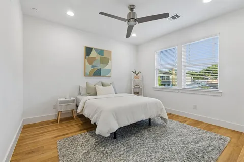 a bedroom with a bed lamps and window