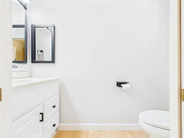 a bathroom with a toilet a sink a mirror and