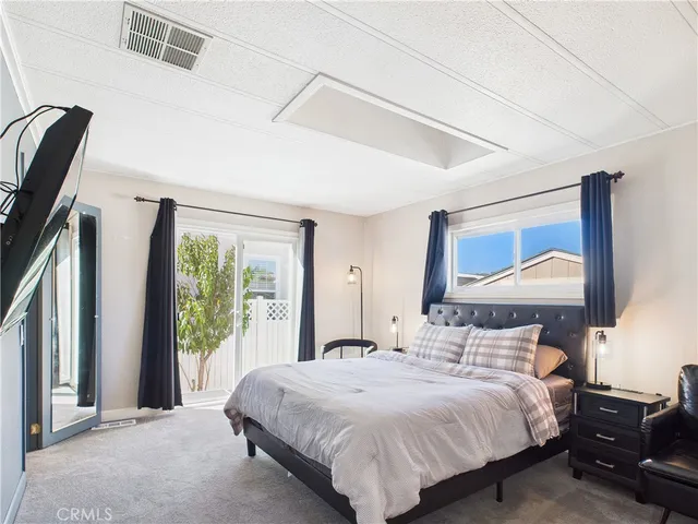 a bedroom with a large bed and a large window