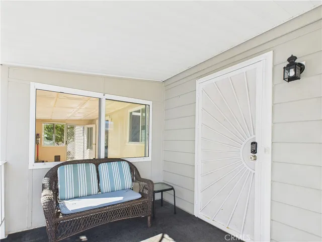 a view of a livingroom with furniture and a window