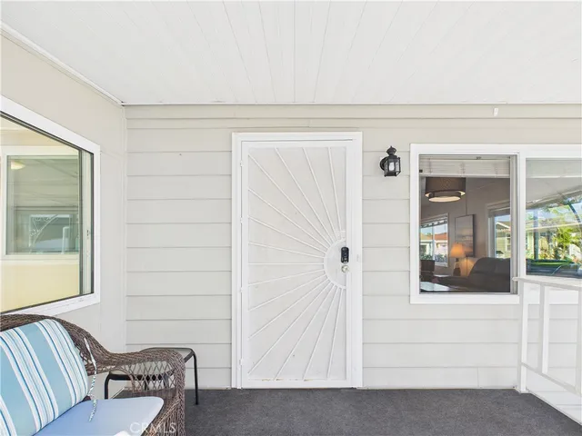 a view of a hallway with furniture and windows