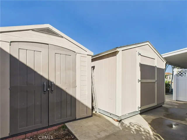 a view of a house with a wooden wall
