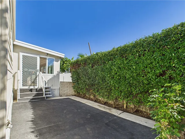 a view of backyard with seating area and green space