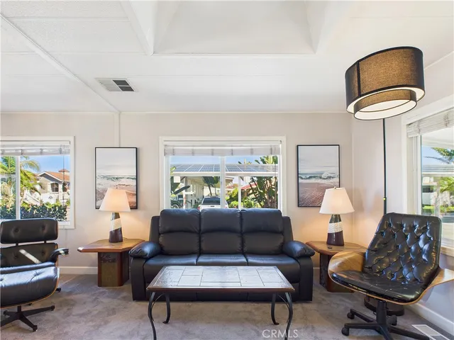 a living room with furniture and a lamp