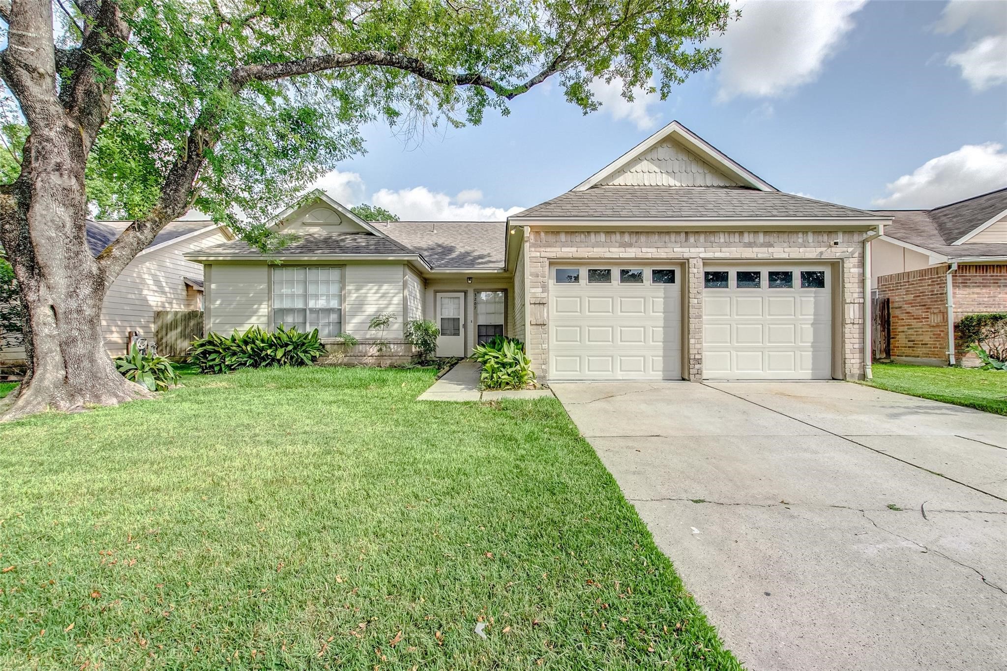 3207 Georgia Pine Drive Spring, TX 77373 - Photo 29 of 29 a front view of a house with a garden and plants