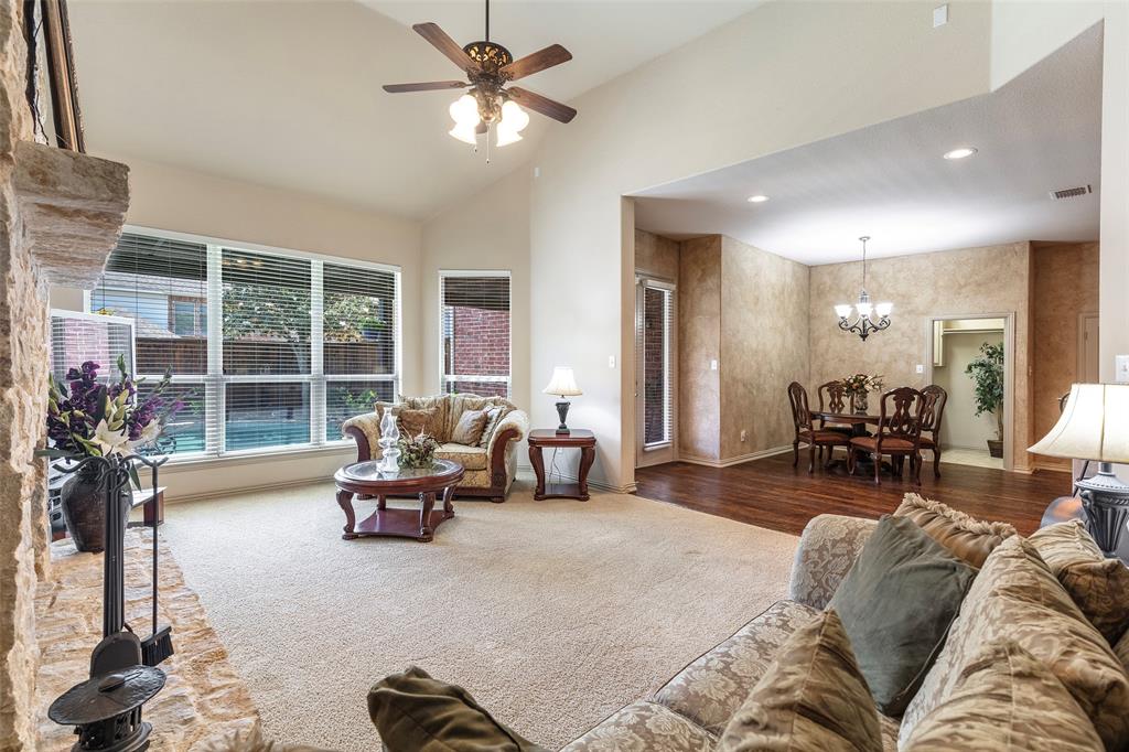 1217 Windmere Way Allen, TX 75013 - Photo 15 of 38 Sunlight pours through expansive windows, creating an airy gathering space that seamlessly connects indoor comfort with views of the backyard retreat.