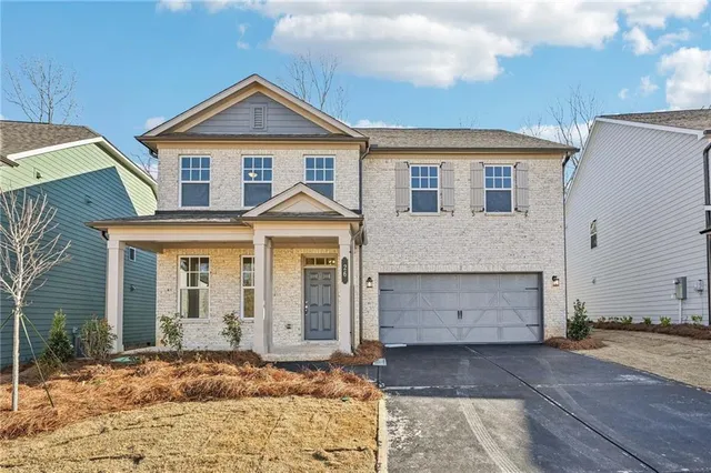 a front view of a house with a yard