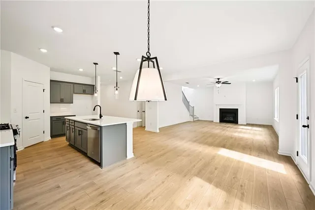 a kitchen with a sink chandelier and a fireplace