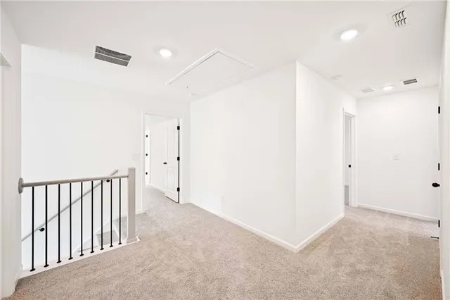 an empty room with a ceiling fan and windows