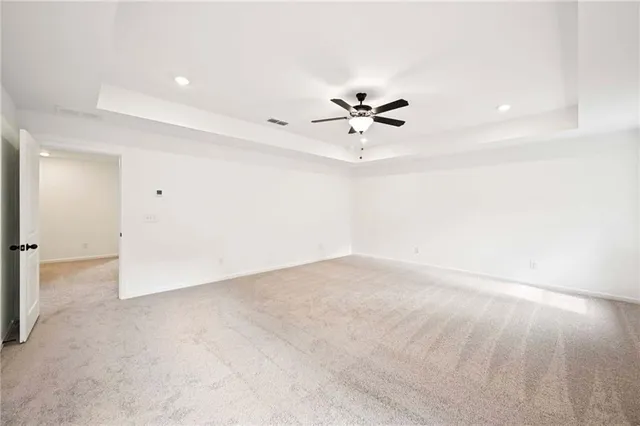 a spacious bathroom with a double vanity sink a large mirror and shower