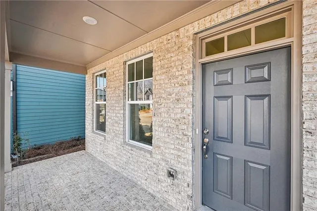 a view of a room with wooden floor and white doors