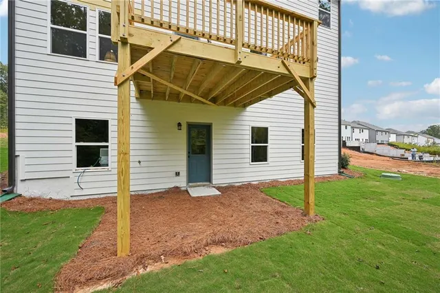 a view of a house with a yard and deck