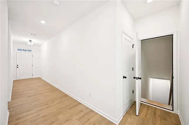 a view of a hallway with wooden floor