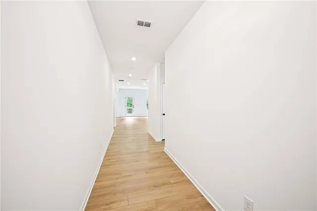 a view of a livingroom with wooden floor and a ceiling fan