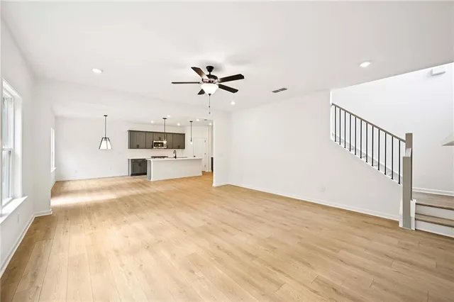 a large kitchen with stainless steel appliances kitchen island a large counter top and a stove top oven