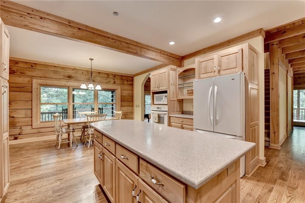 82 Walnut Grove Lane Tiger, GA 30576 - Photo 22 of 88 a kitchen with stainless steel appliances granite countertop a refrigerator a stove and a wooden floors