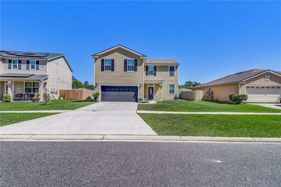 a front view of a house with a yard and garage