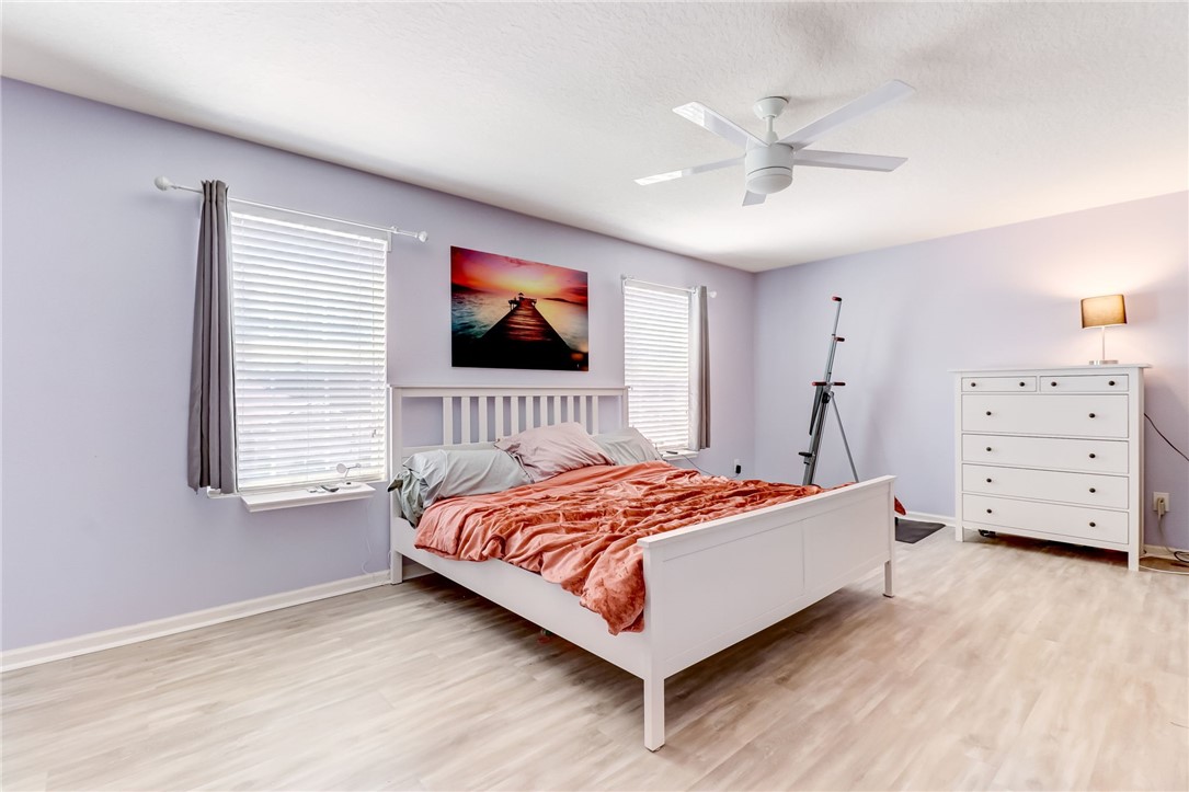45170 Dutton Way Callahan, FL 32011 - Photo 16 of 35 a bedroom with a bed and a flat tv screen