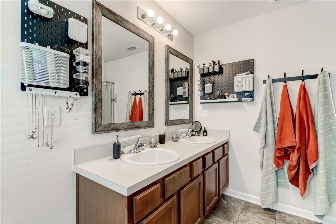 45170 Dutton Way Callahan, FL 32011 - Photo 18 of 35 a bathroom with a sink vanity and mirror