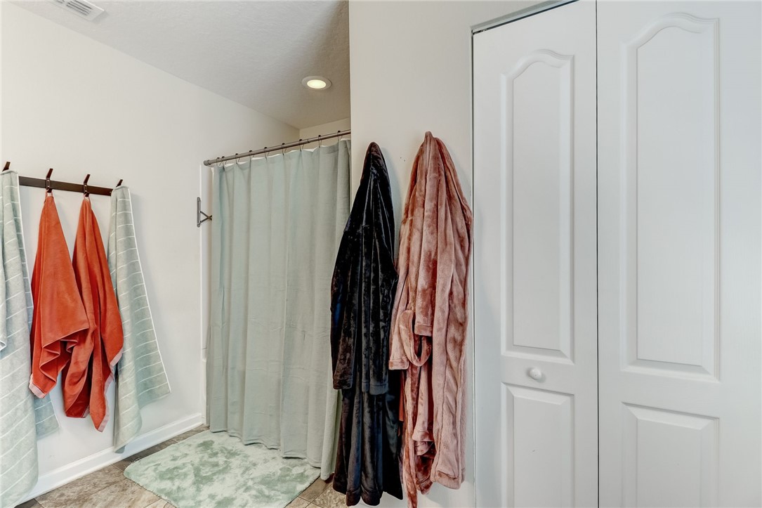 45170 Dutton Way Callahan, FL 32011 - Photo 19 of 35 a view of walk in closet with clothes