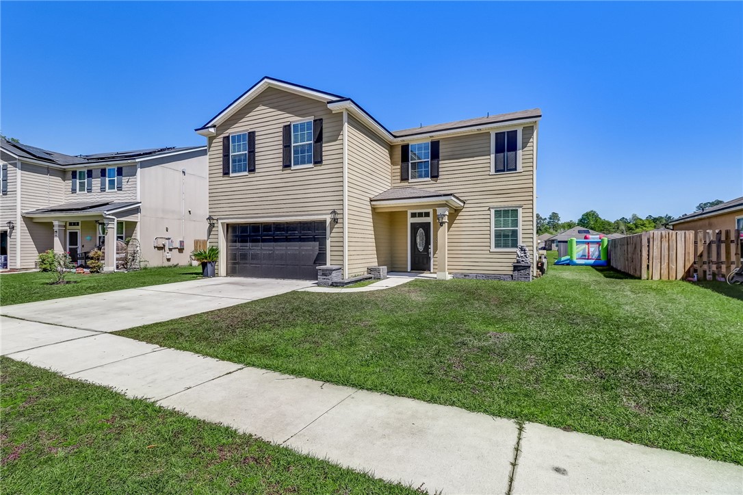 45170 Dutton Way Callahan, FL 32011 - Photo 2 of 35 a front view of a house with a yard