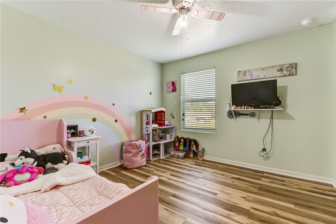 45170 Dutton Way Callahan, FL 32011 - Photo 22 of 35 a view of a workspace with furniture and a flat screen tv