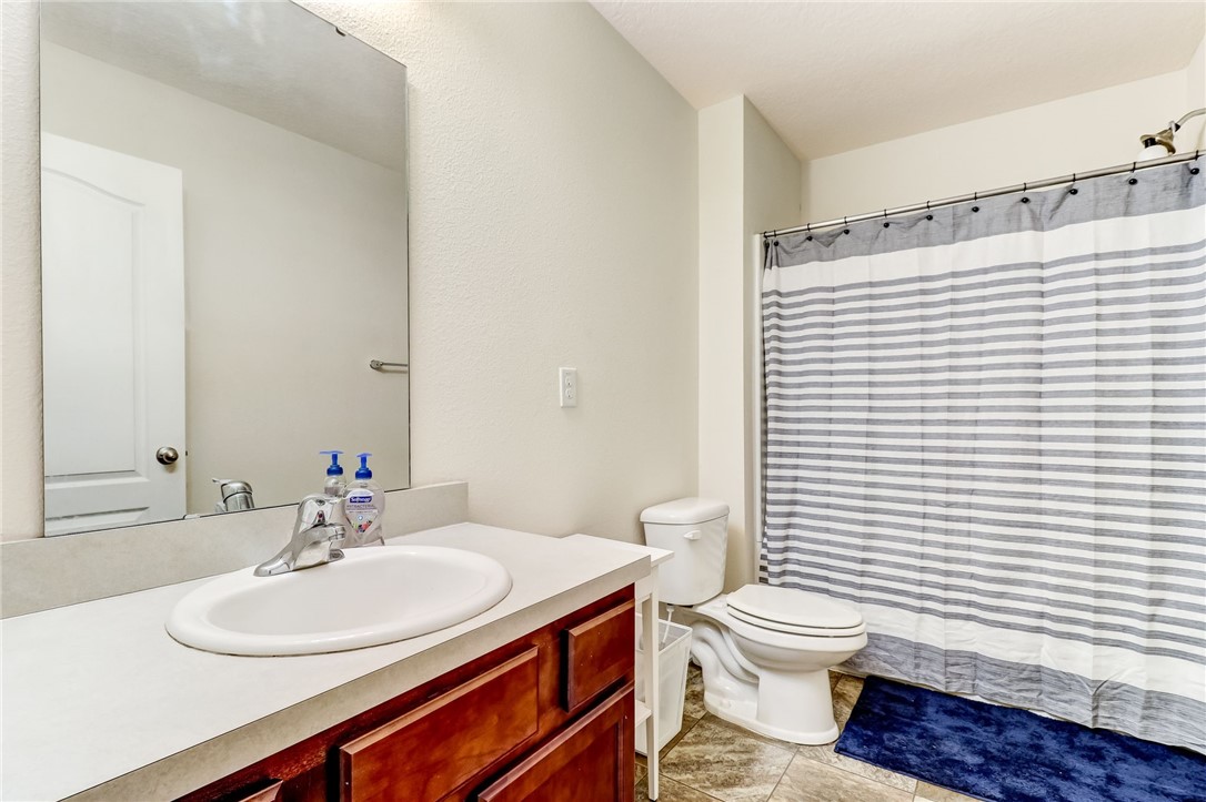 45170 Dutton Way Callahan, FL 32011 - Photo 24 of 35 a bathroom with a sink a toilet and shower curtain