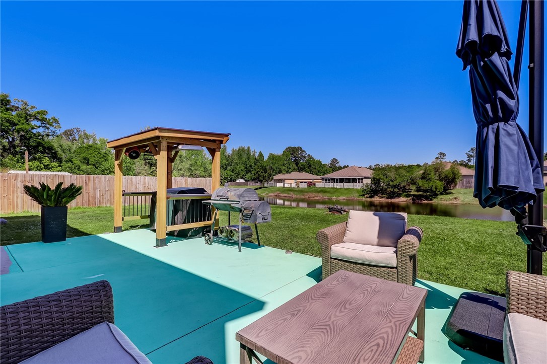 45170 Dutton Way Callahan, FL 32011 - Photo 27 of 35 a view of a chairs and table in patio with a yard