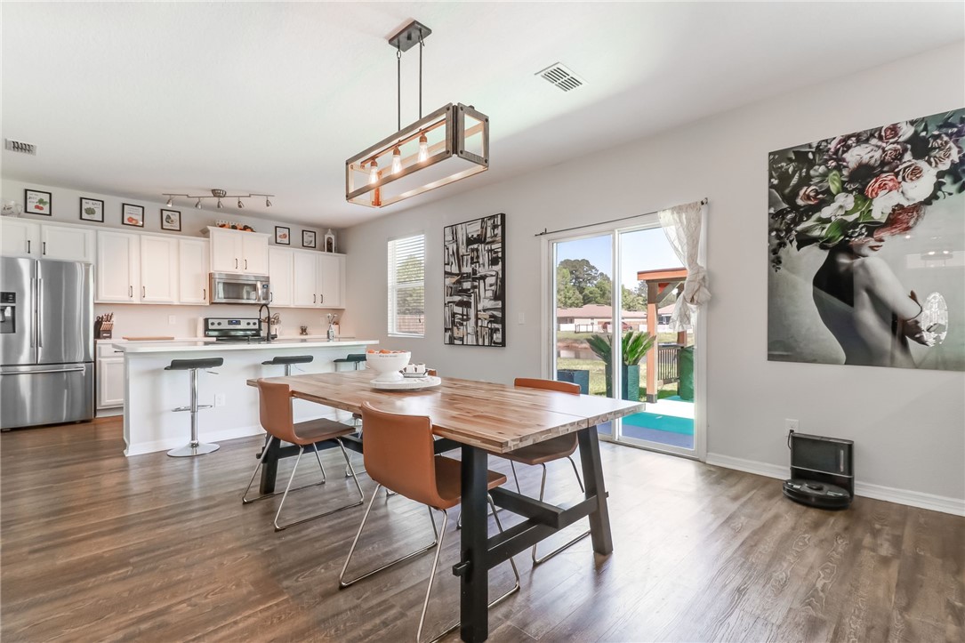 45170 Dutton Way Callahan, FL 32011 - Photo 6 of 35 a view of a dining room with furniture window and wooden floor