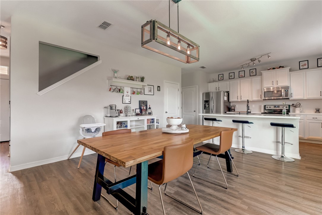 45170 Dutton Way Callahan, FL 32011 - Photo 8 of 35 a view of a dining room with furniture and wooden floor