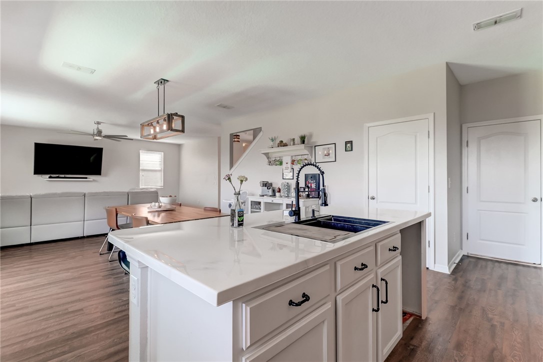 45170 Dutton Way Callahan, FL 32011 - Photo 9 of 35 a kitchen with stainless steel appliances a sink and a stove