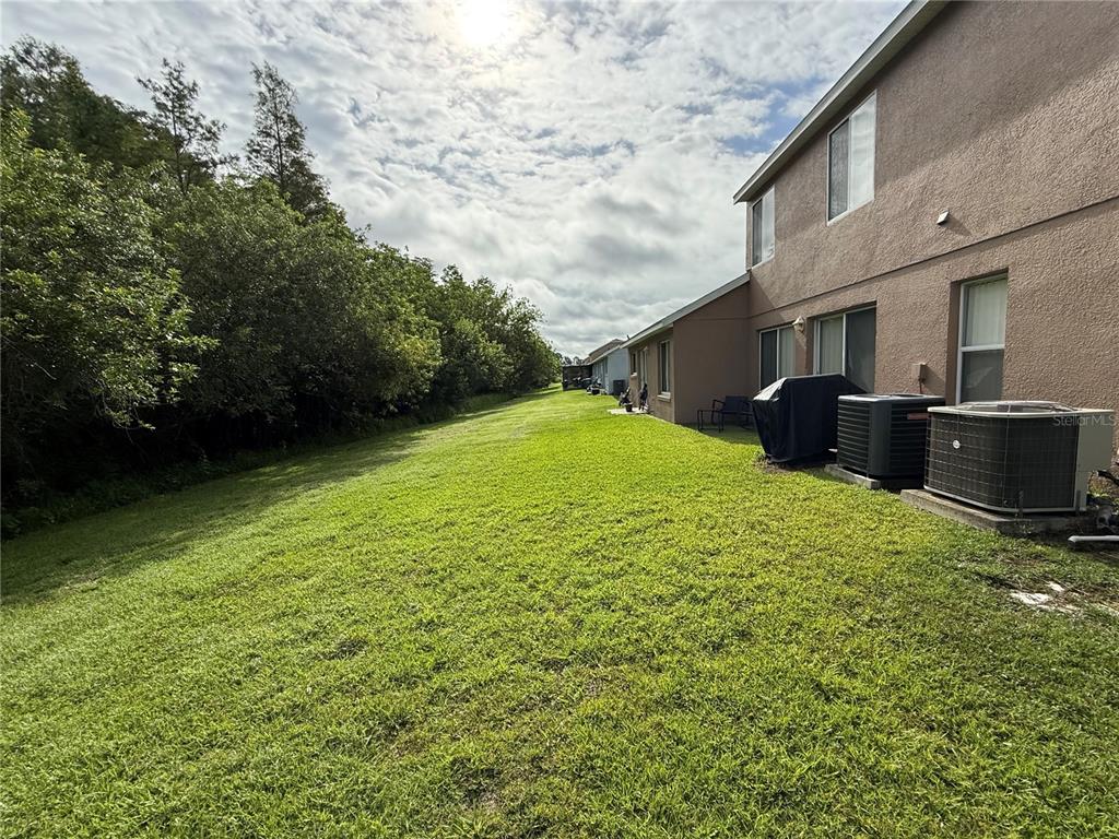 Undisclosed Address Orlando, FL 32824 - Photo 3 of 5 a backyard of a house with lots of green space